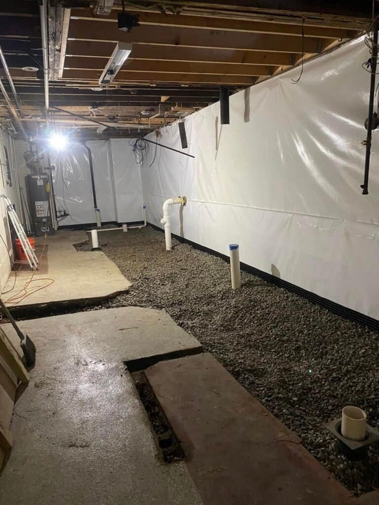 Basement waterproofing installation in progress