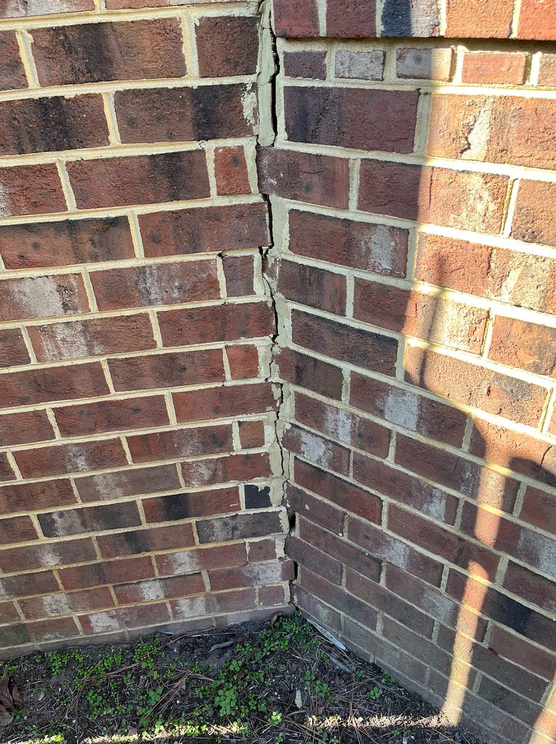 Stair-step crack pattern in concrete block foundation wall