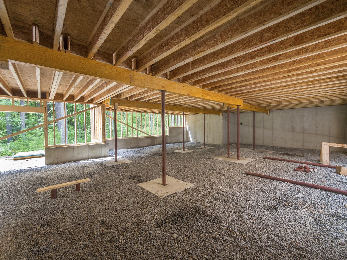 Foundation repair crew installing carbon fiber reinforcement strips on a basement wall